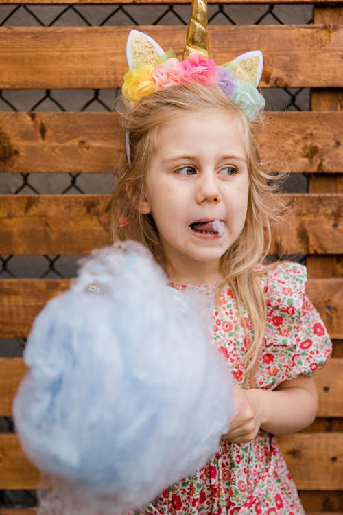 Cute Girl Eating Cotton Candy