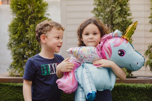 Kids Holding a Unicorn Balloon
