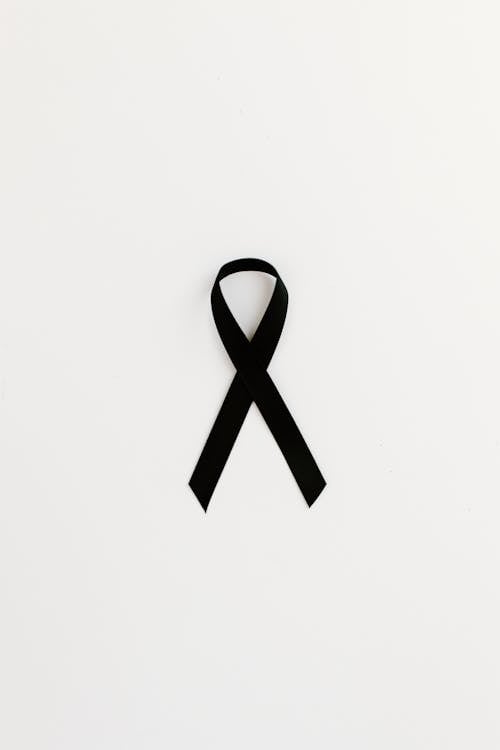 Close-Up Shot of a Black Ribbon on White Background