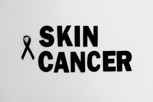 Free Text Saying "Skin Cancer" on White Background  Stock Photo