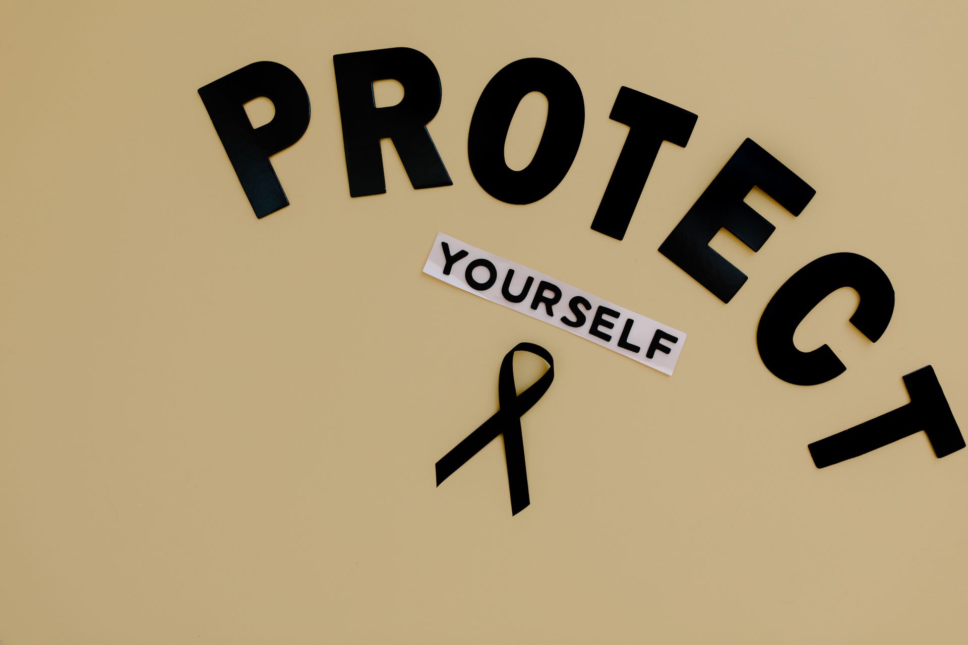 Protect Yourself Text on Brown Surface