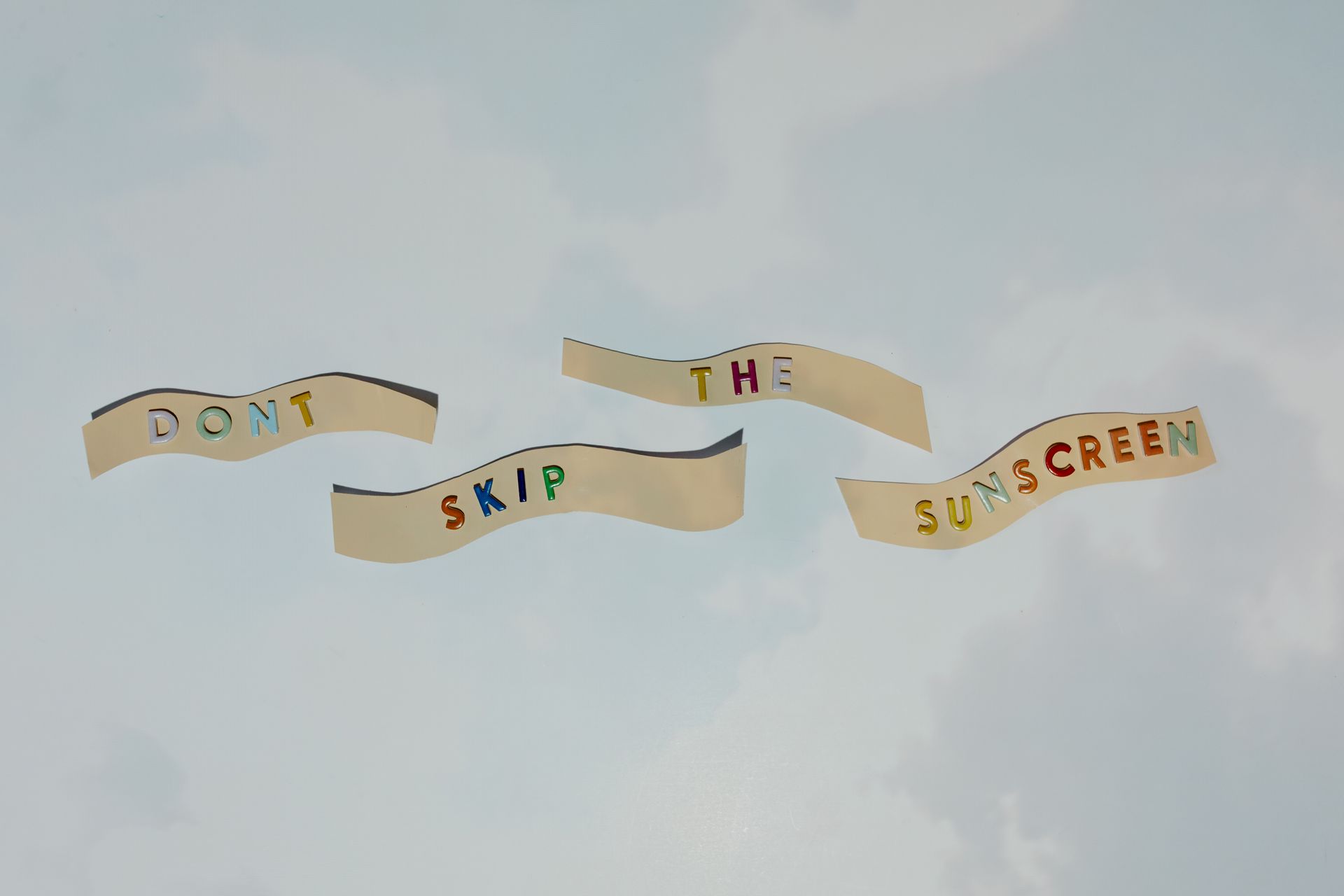 Top View of a Colorful Text Saying "Dont Skip the Sunscreen"