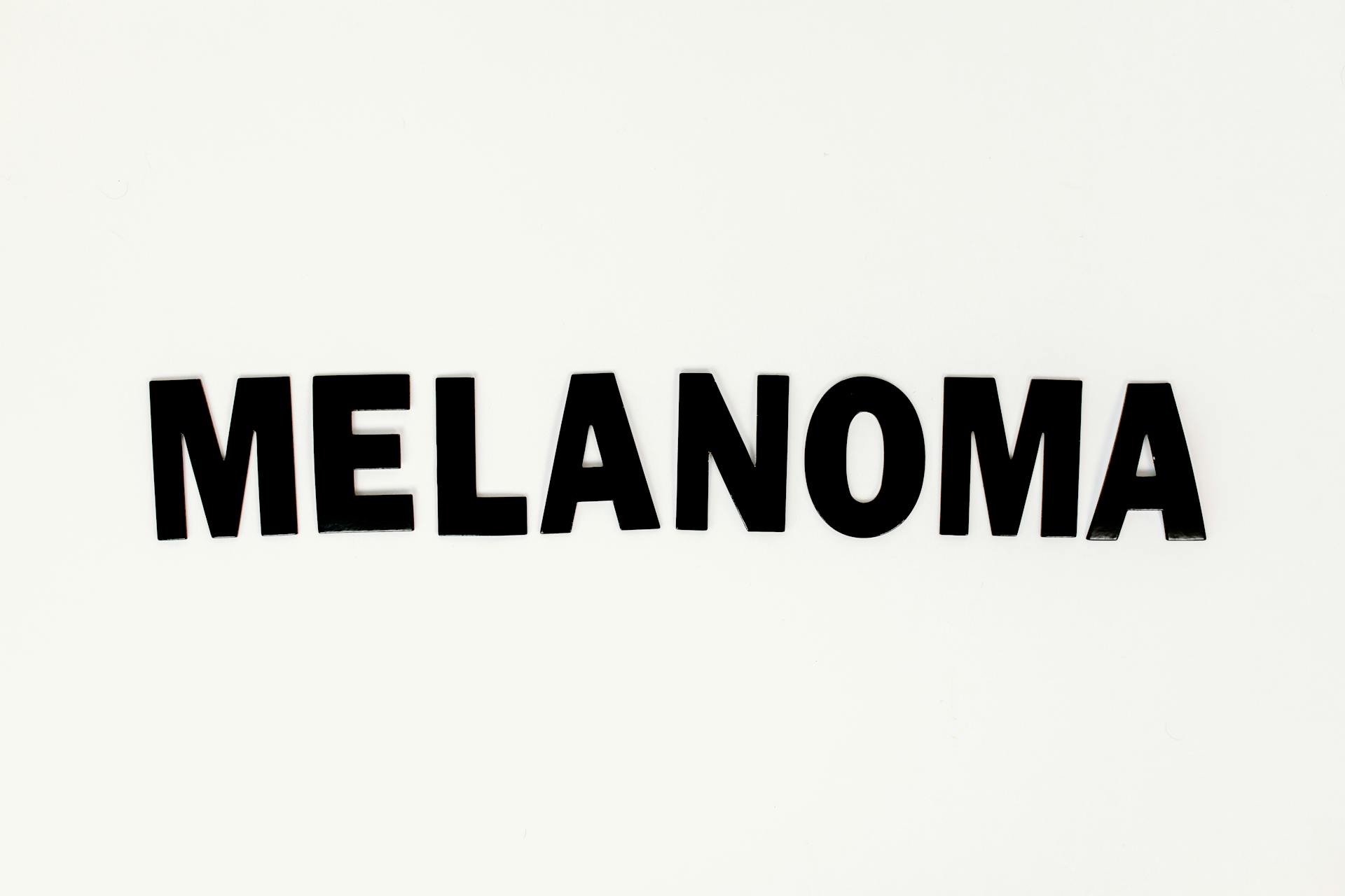 A Black Melanoma Text on White Surface