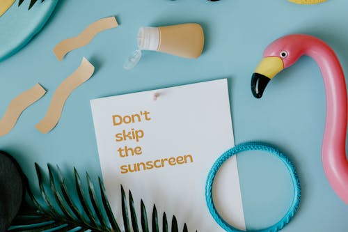 Free Sunscreen over Card with Skin Cancer Awareness Slogan Stock Photo