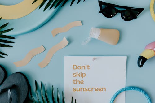 Free Paper with a Text Saying "Dont Skin the Sunscreen"  Stock Photo