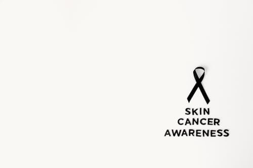 Black Ribbon over Skin Cancer Awareness Text