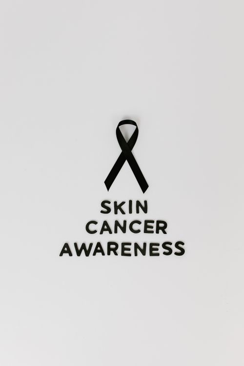 Free Black ribbon symbolizing skin cancer awareness on a white background. Stock Photo