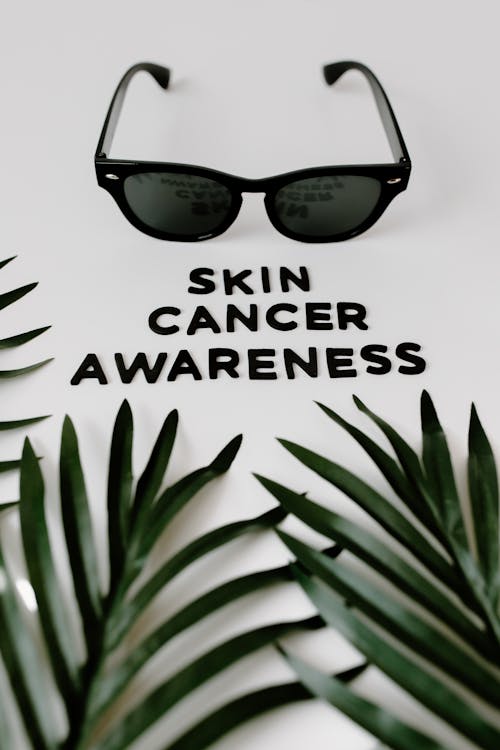 Free Sunglasses and Leaves by Text About Skin Cancer Awareness Stock Photo