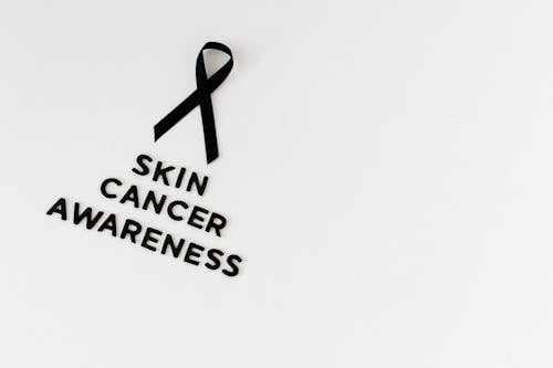 Free Black Ribbon and Text Saying "Skin Cancer Awareness" Stock Photo