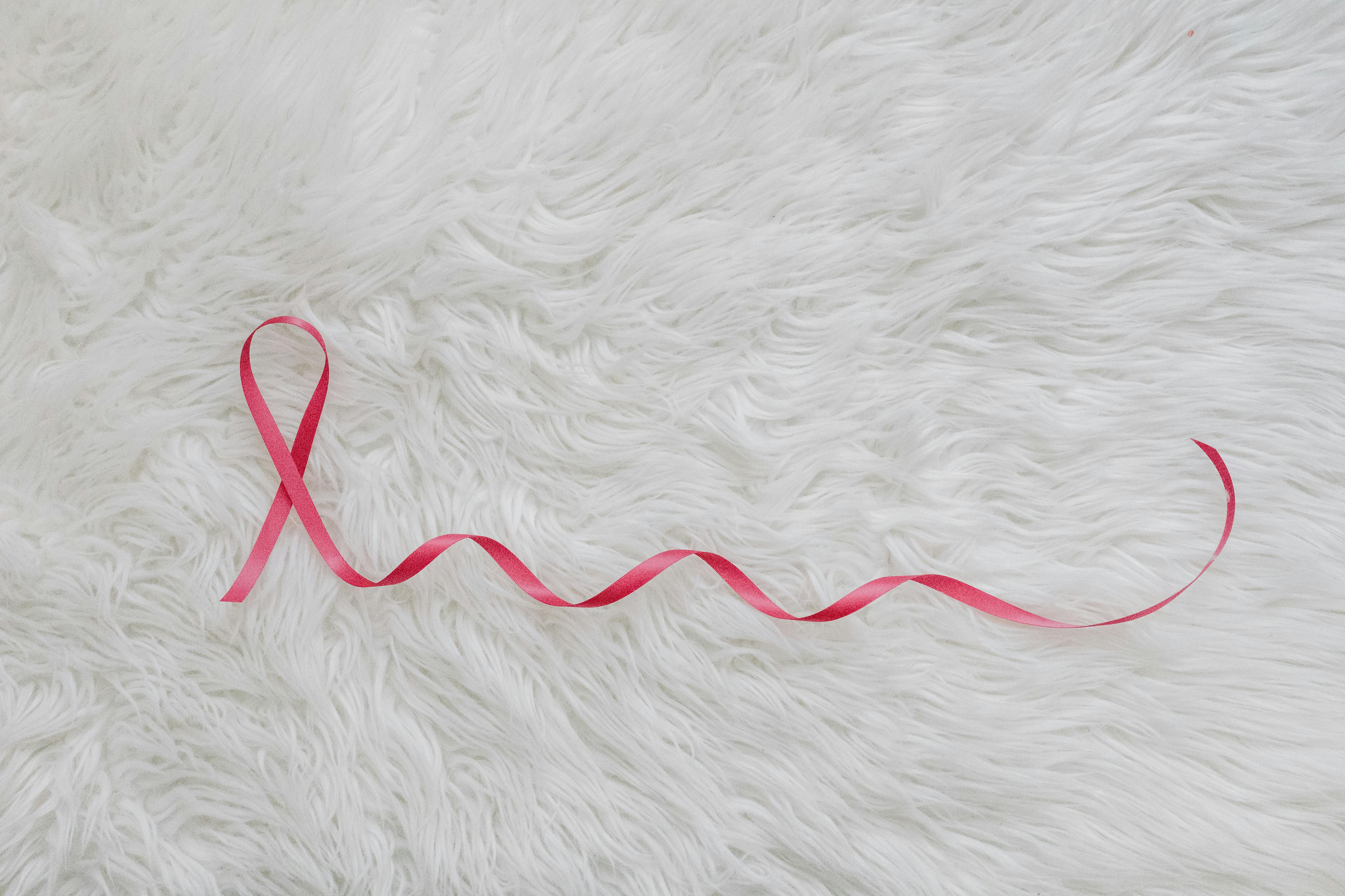 pink ribbon on white fur