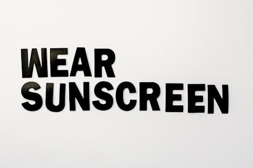 Free Black Text Saying "Wear Sunscreen" on White Background  Stock Photo