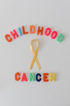 Colorful childhood cancer awareness ribbon isolated on a white background.