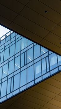 Explore this modern architectural shot featuring a geometric glass facade and structural lines.