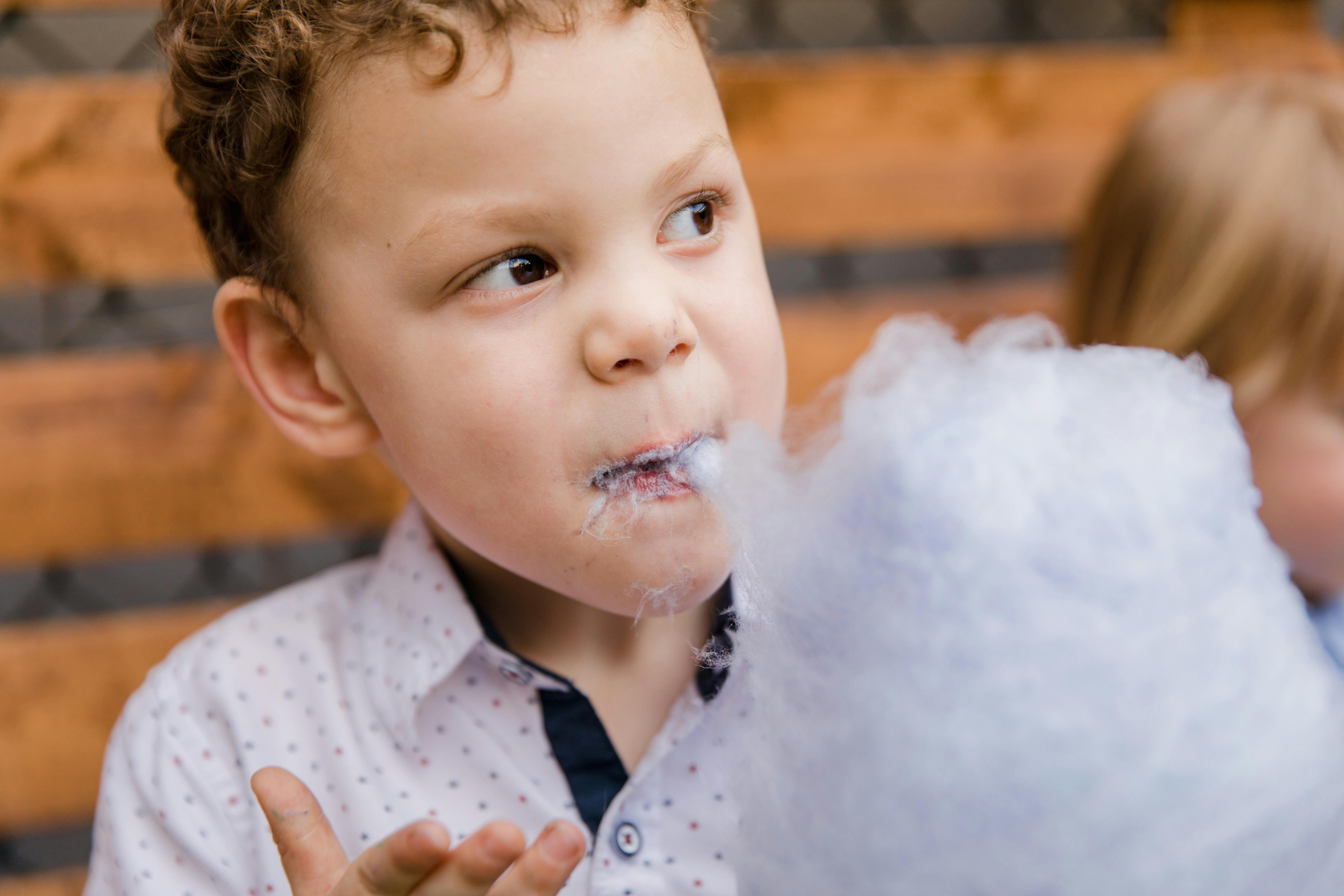 A Boy Eating Cotton Candy · Free Stock Photo