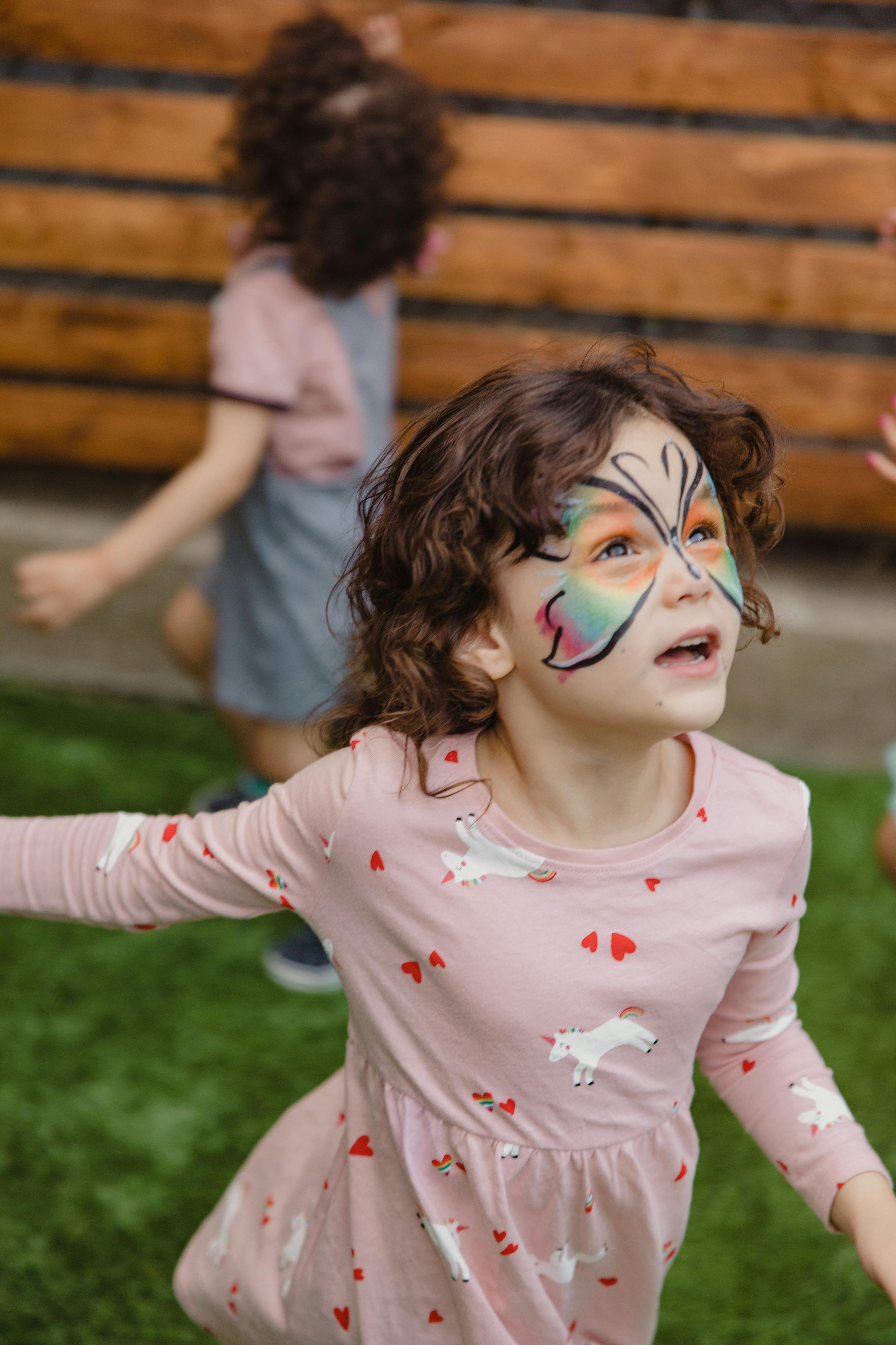 a girl running on the green grass