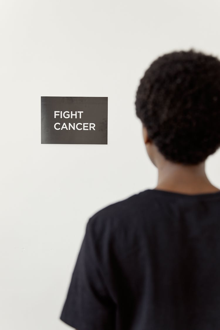 Back View Of A Person Looking At A Sign On A Wall Saying 