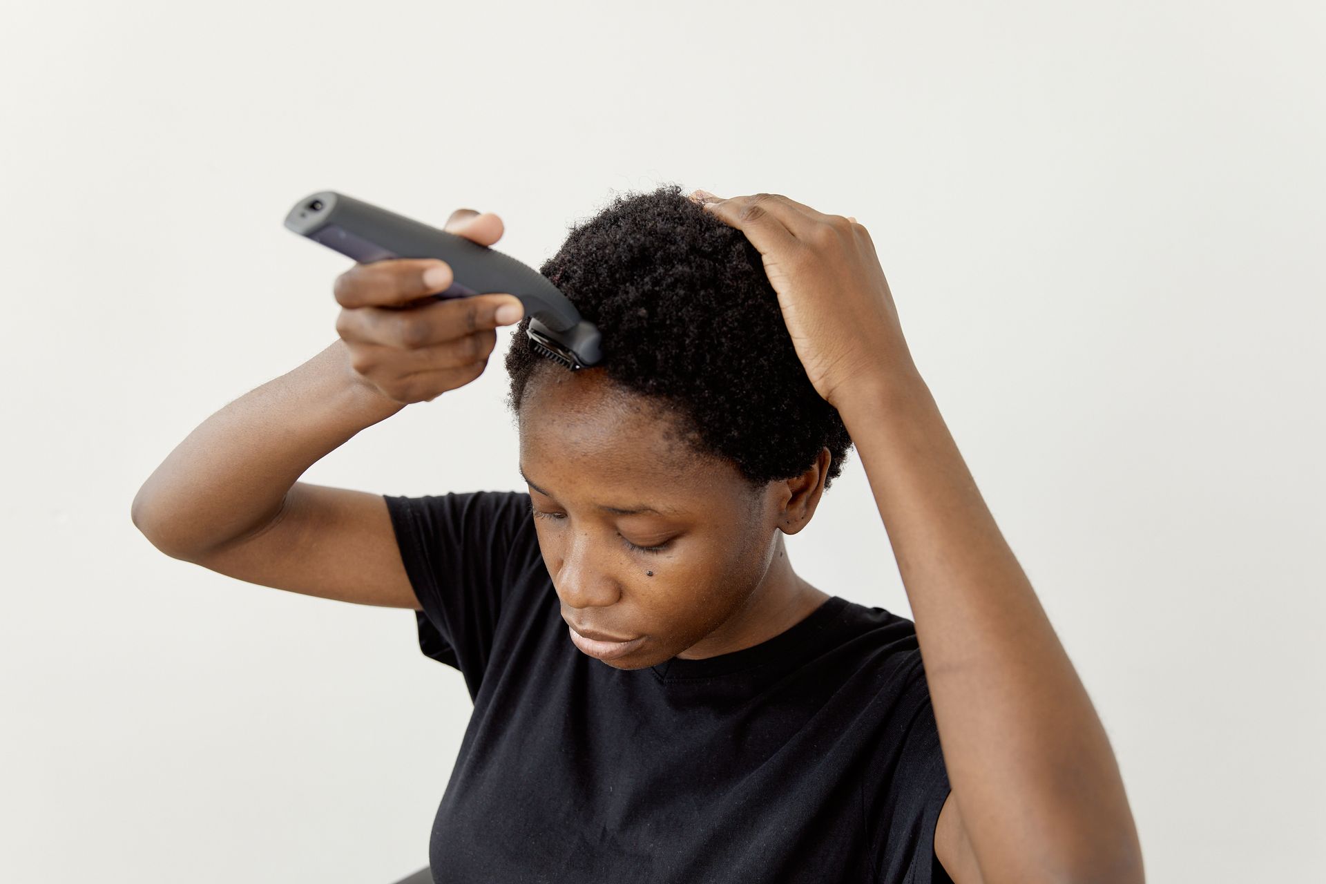 Woman using Hair Clippers on her Hair