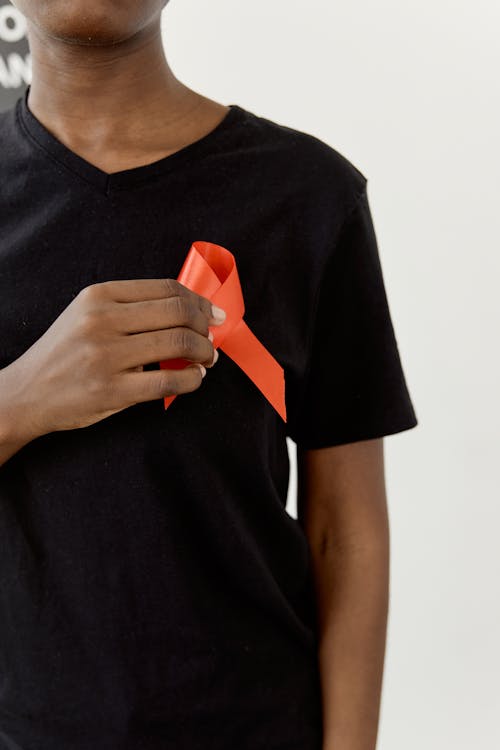 Person holding an Orange Ribbon