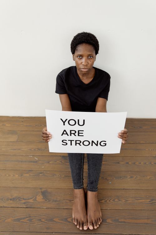 Free A person holding a 'You Are Strong' sign, symbolizing strength and empowerment. Stock Photo