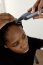 Woman using Hair Clippers on her Hair