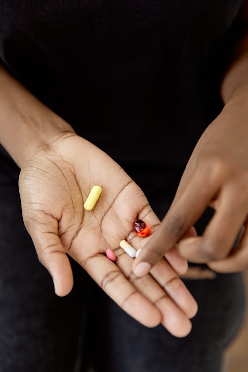 Close-up Photo of Handful of Medicines 