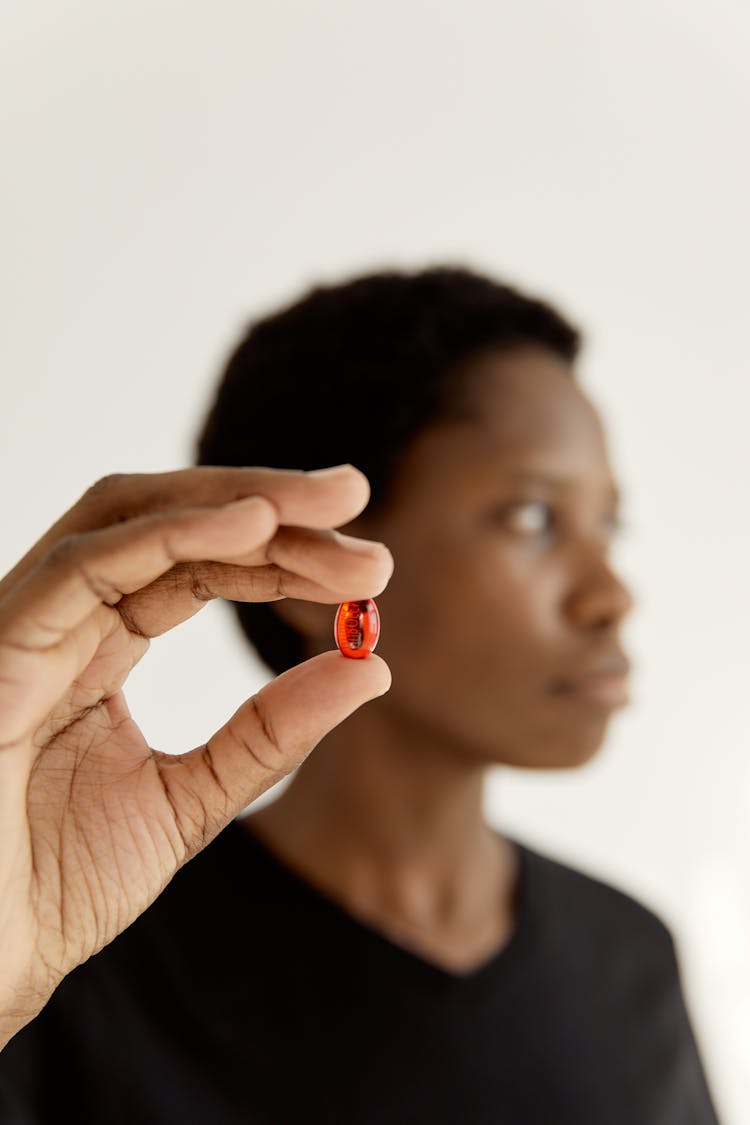 A Woman Holding A Pill