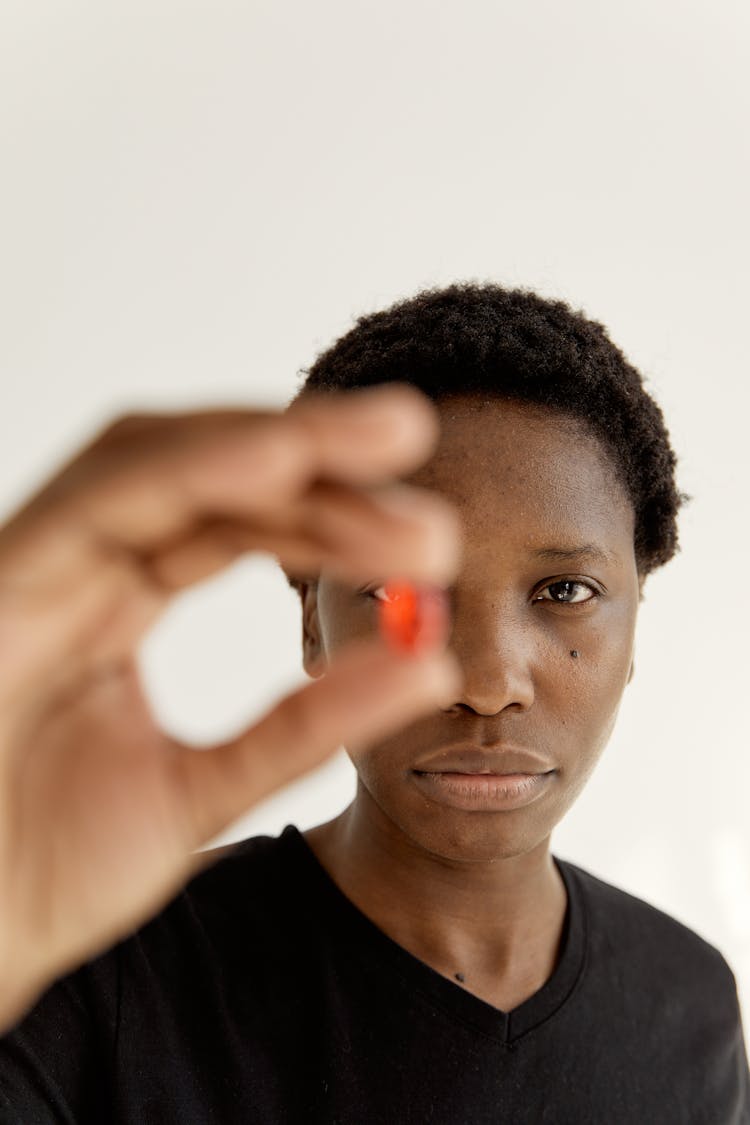 A Woman Holding A Pill