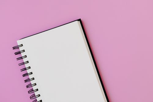 Free White Spiral Notebook on Pink Background Stock Photo