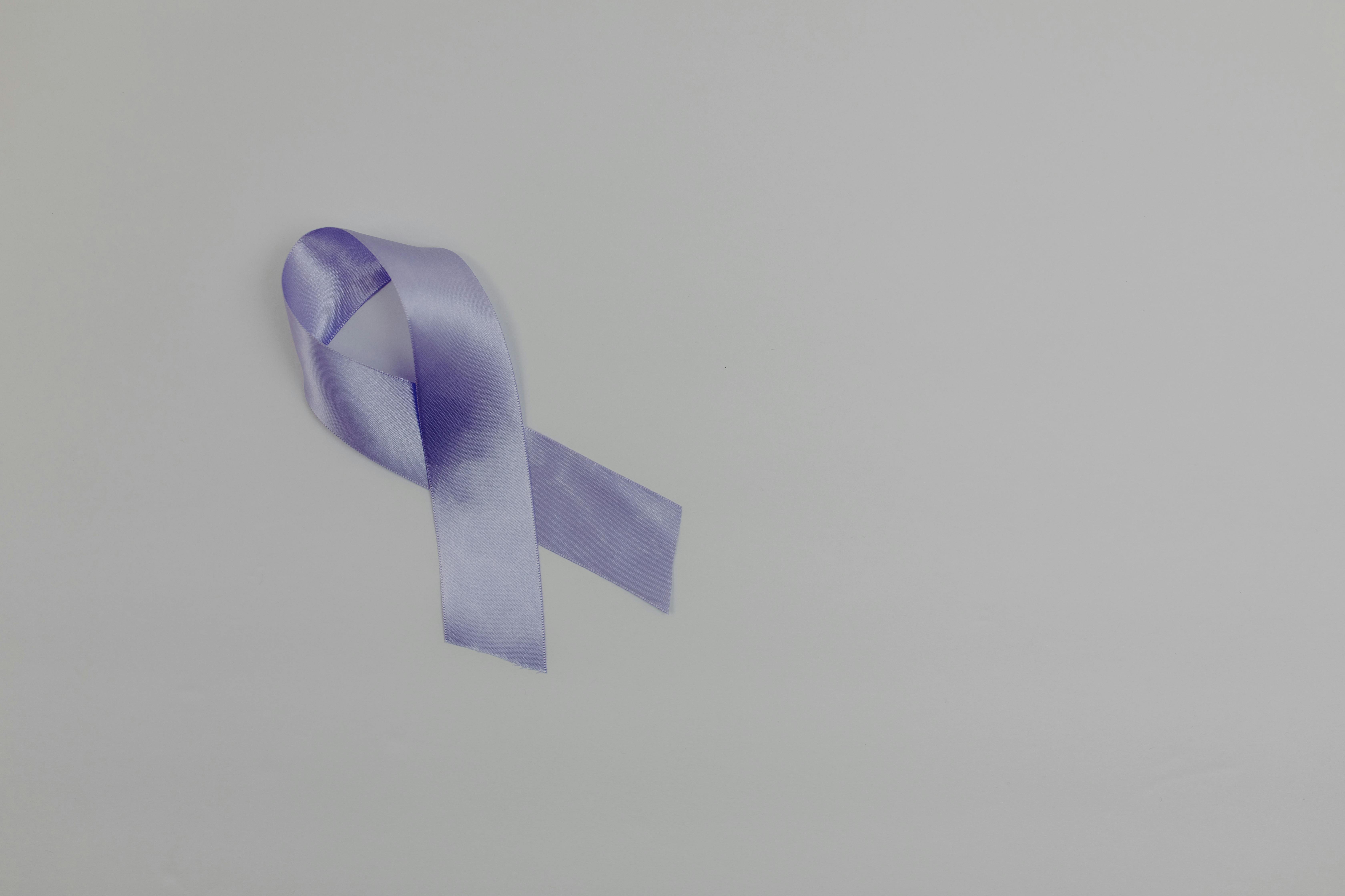 cancer ribbon on white surface