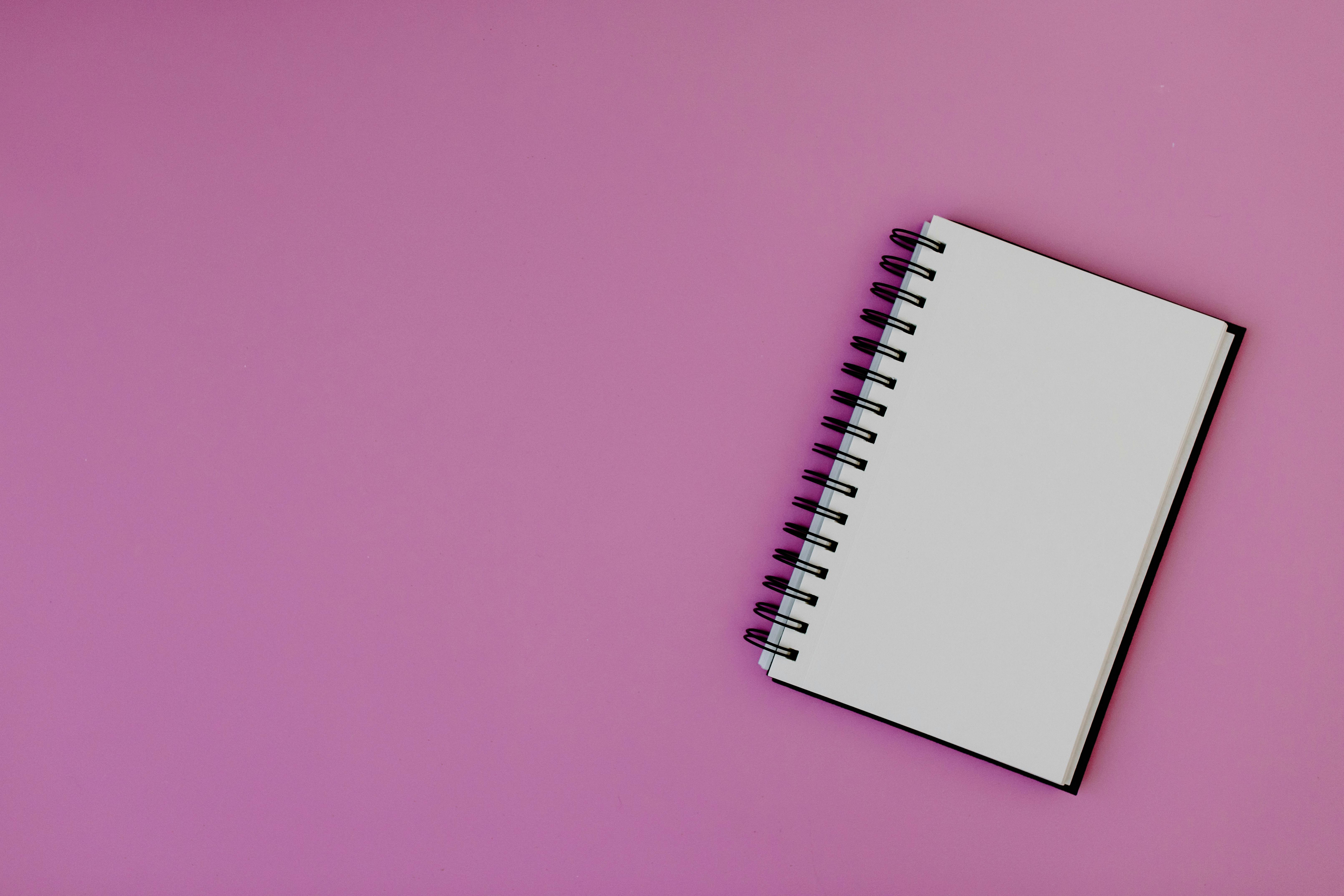 Blank page of vertical spiral sketching pad with crayons on pink  background, flat lay. Back to school Stock Photo - Alamy