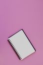 An Empty Notebook on a Purple Background