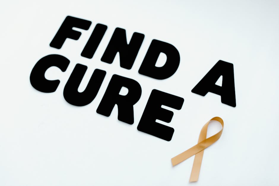 Image of a gold awareness ribbon with the message 'Find a Cure' on a white background.
