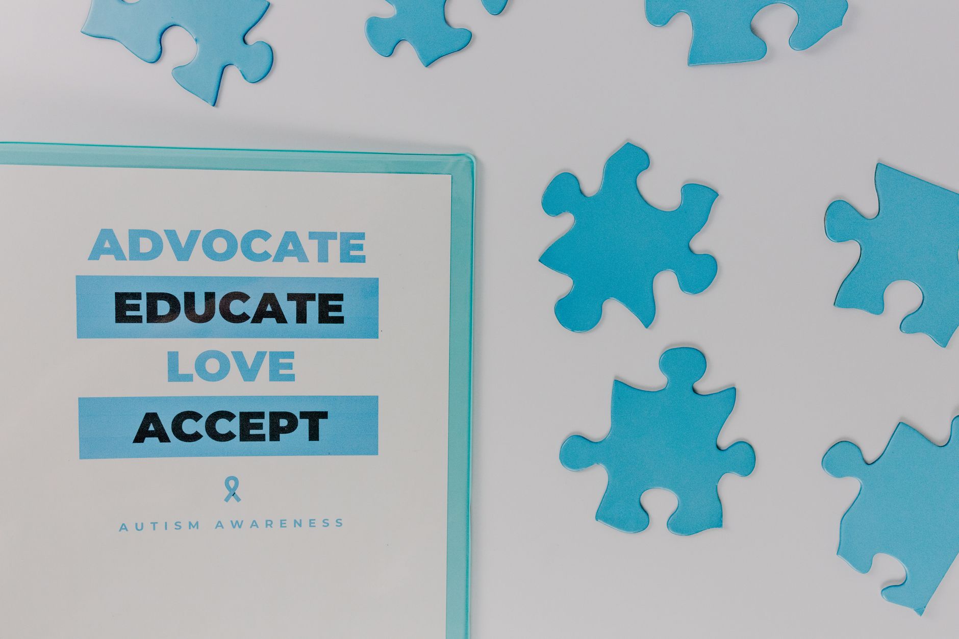 Close-up of autism awareness poster with blue puzzle pieces.