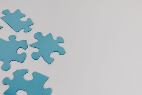 Free Close-up of blue puzzle pieces on a white background with copy space. Stock Photo