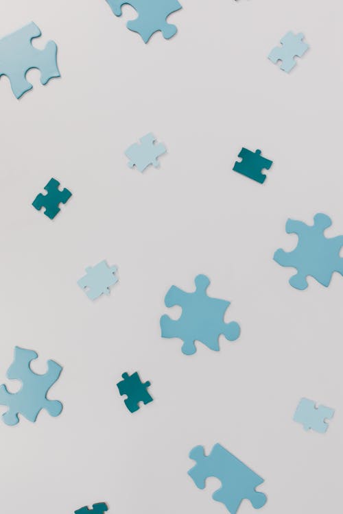 Free Puzzle Pieces on a White Surface Stock Photo