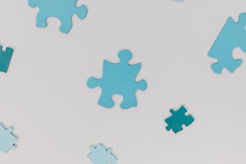Puzzle Pieces on White Surface