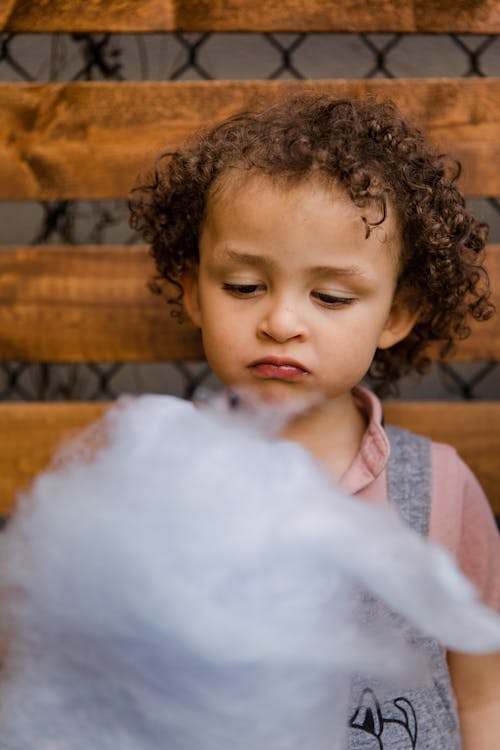 Cute Little Girl Eating Cotton Candy