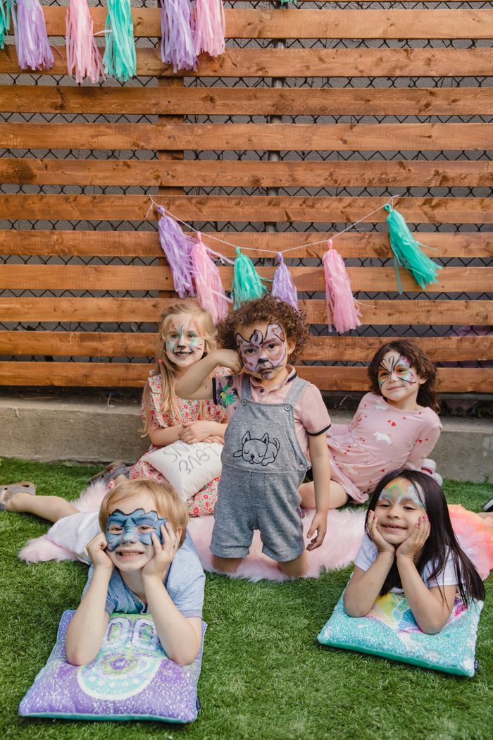 Smiling children with painted faces during an outdoor event