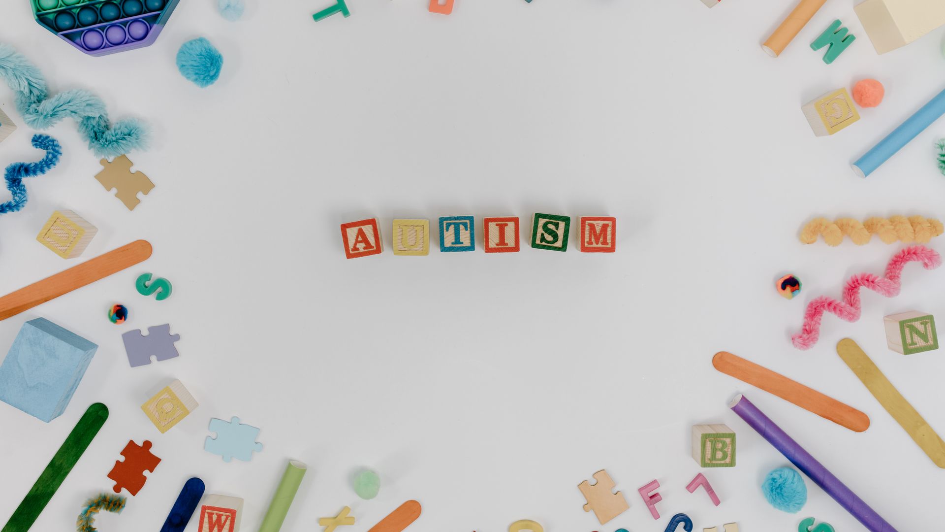 Modafinil for Autism Related Fatigue: Exploring the Benefits Brightly colored blocks and toys arranged around the word autism, promoting awareness — modafinil for autism related fatigue