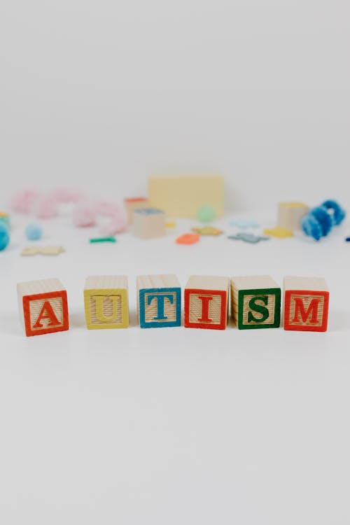 Free Autism spelled using Wooden Blocks on a White Surface Stock Photo