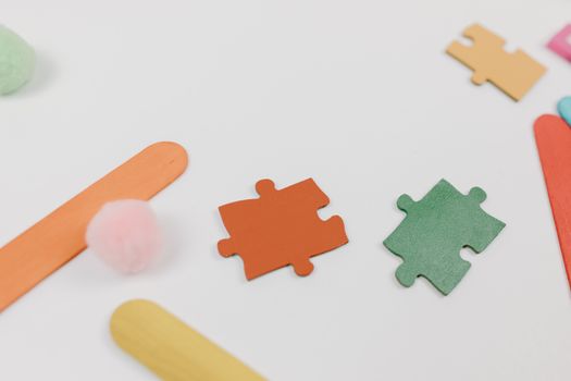 A vibrant arrangement of puzzle pieces and crafting materials creating a playful and creative scene.
