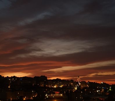 A stunning city skyline at dusk with vibrant colors and dramatic clouds.