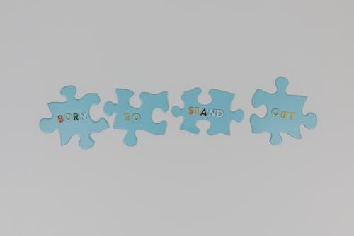 Puzzle Pieces with Letters on White Background