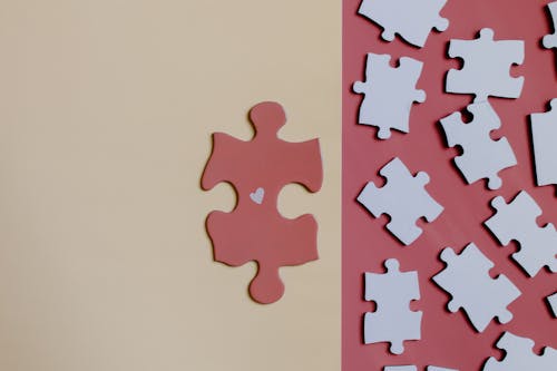 Free Brown Jigsaw Puzzle Piece on White Table Stock Photo