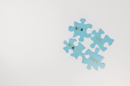 Free Jigsaw Puzzle Pieces on White Surface Stock Photo