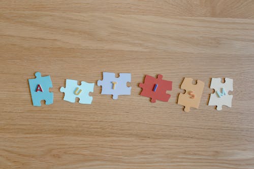 Free Puzzle Pieces with Cutout Letters Stock Photo
