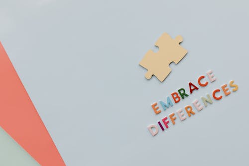 Free Embrace Differences Text by Puzzle on Paper Stock Photo