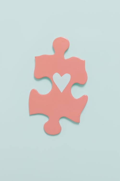 Free A Pink Jigsaw Puzzle Piece with Drawing of a Heart Stock Photo