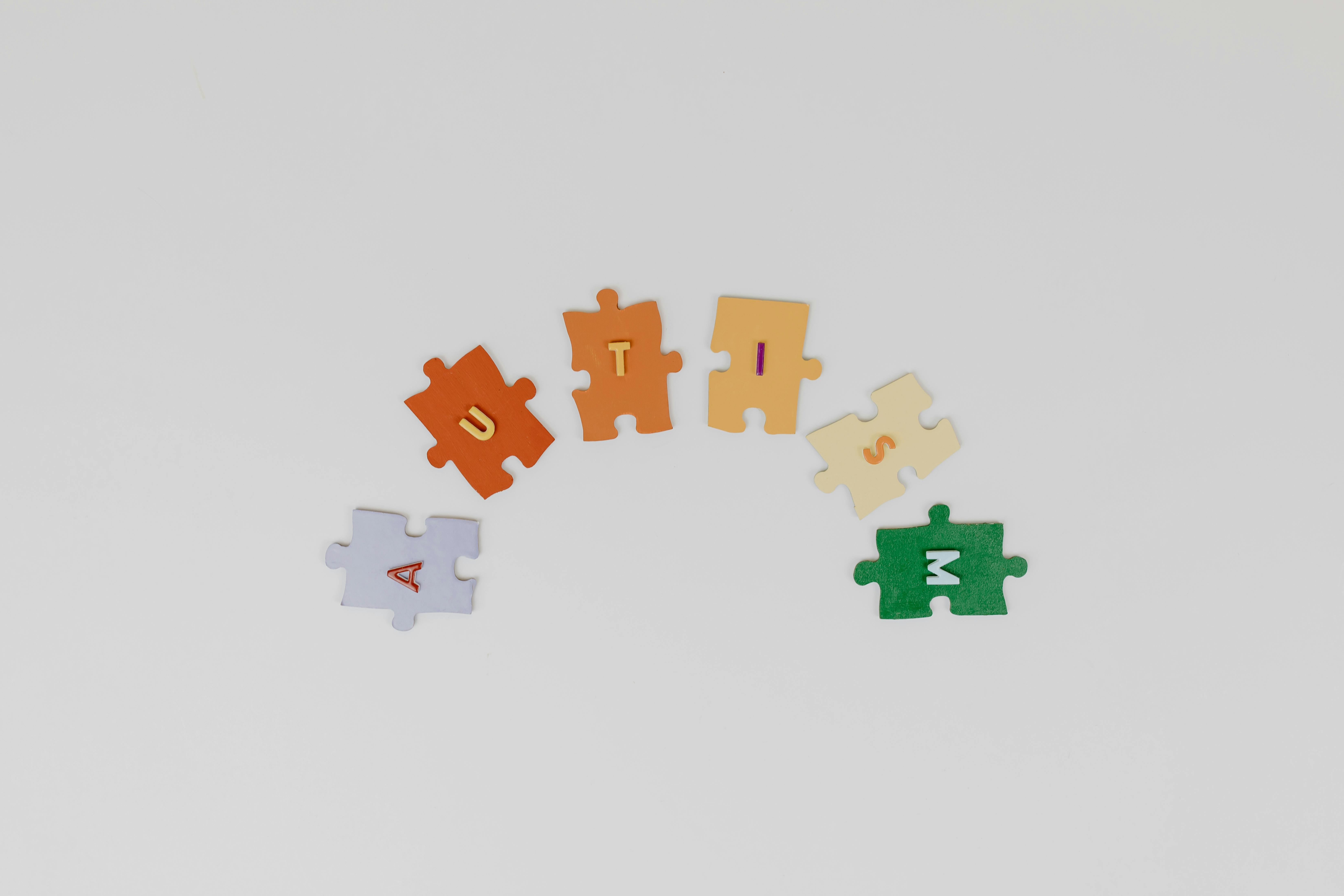 Colorful puzzle pieces arranged to spell 'Autism' highlighting autism awareness.