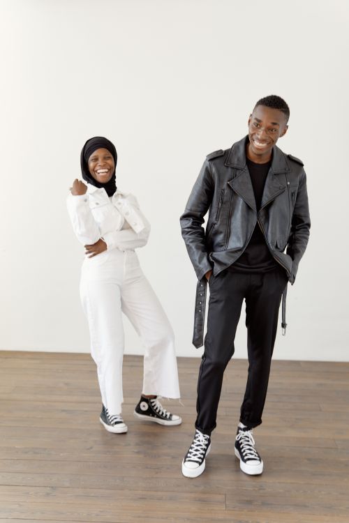 Free A joyful black Muslim couple in stylish outfits posing indoors with a bright background. Stock Photo
